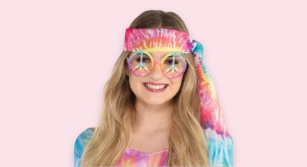 A woman wearing a disco themed headband and glasses.