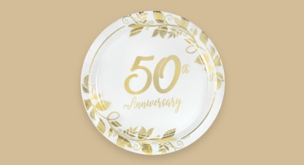 A white and gold plate that reads "50th Anniversary".