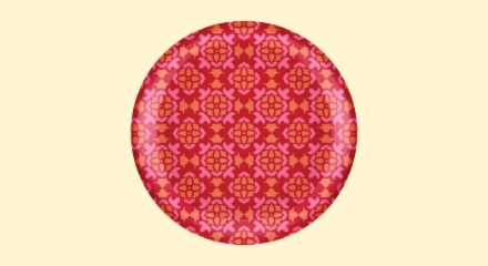 A round paper plate with a red geometric pattern.
