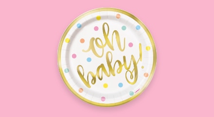 A wihite, gold and polka dot-coloured  plate that says "Oh baby!".