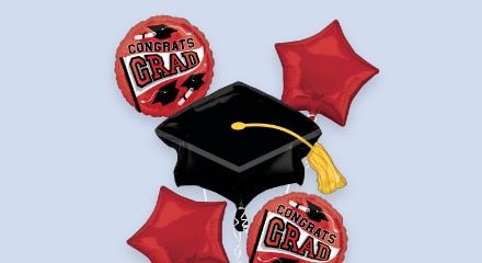 A bouquet of red and black graduation balloons.
