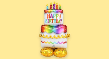 A foil balloon shaped like a birthday cake.