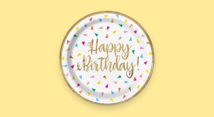 A confetti-patterned plate that reads "Happy birthday".