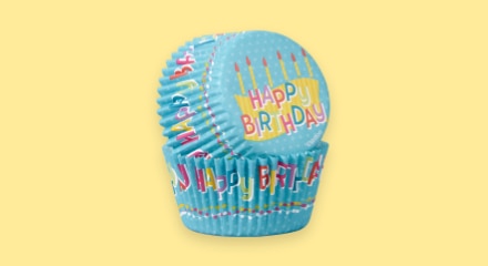 Blue paper baking cups that read 'HAPPY BIRTHDAY'.
