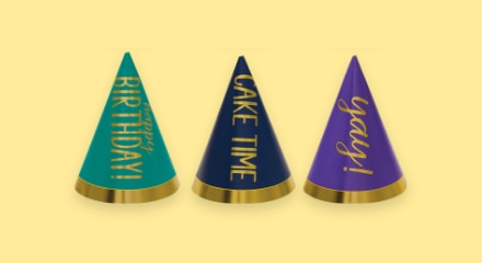 Green, black and purple-coloured birthday hats with various birthday-themed sayings.