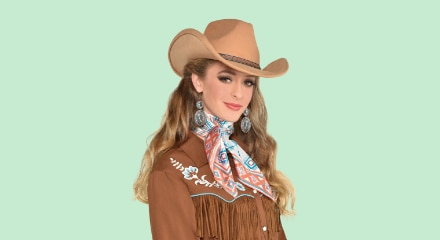 A woman dressed in a cowgirl outfit.