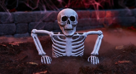 A skeleton breaking out of the ground decoration.