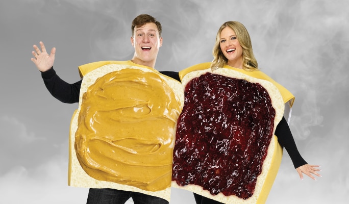 A man and a woman wearing a peanut butter and jelly costume.