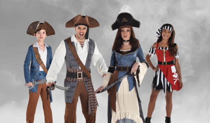 Two adults and two children wearing assorted pirate costumes and accessories.