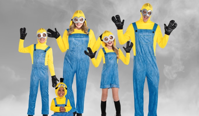 Two kids, a baby and two adults wearing matching Minions costumes and accessories.