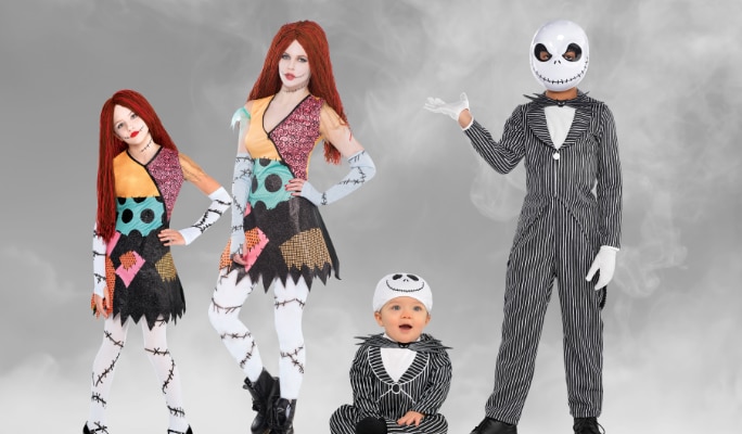 A girl and a woman in matching Sally costumes and a man and a baby in matching Jack Skellington costumes. 