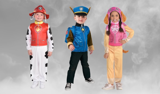 Three children wearing PAW Patrol Marshall, Chase and Skye character costumes.