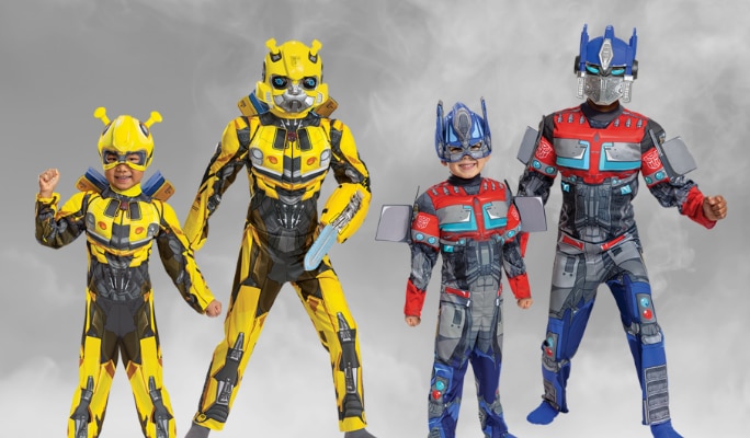 Two adults and two children wearing Transformers Bumblebee costumes and Optimus Prime costumes. 