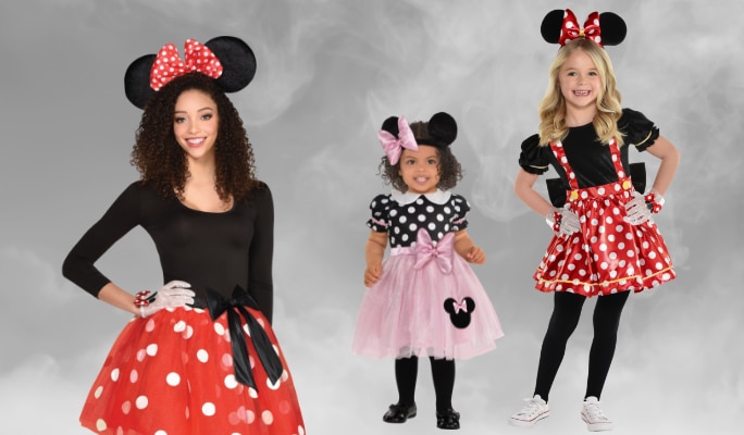 A woman and two girls wearing Mini Mouse costumes.