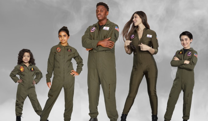 Two adults and three kids dressed in matching Top Gun flight suit costumes.