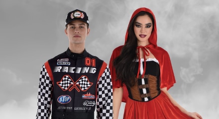 One person dressed as a racecar driver and one person dressed as Little Red Riding Hood.