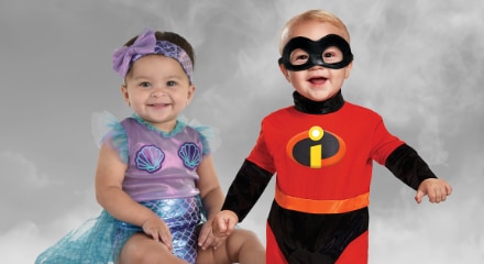 One baby dressed as a mermaid and one dressed as a character from the Incredibles.