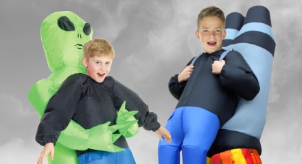 Two children wearing inflatable costumes.