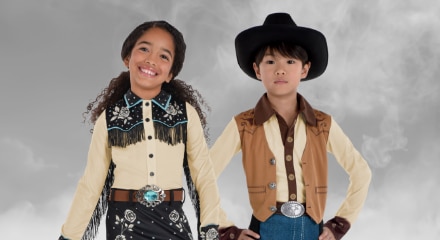 Two people wearing cowboy and cowgirl costumes.