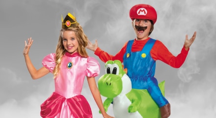 One person dressed as Princess Peach and one dressed as Super Mario riding Yoshi.