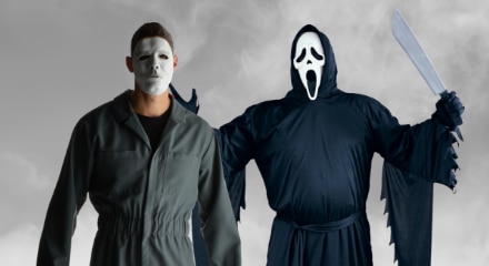 Two people wearing slasher movie character costumes.