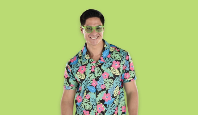 A person wearing green glasses and a flower-patterned shirt.