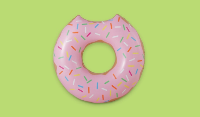 A pink sprinkle doughnut-shaped pool float.