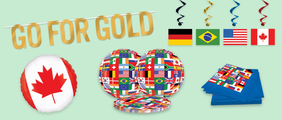 A banner that reads 'GO FOR GOLD', hanging flag decor, a Canada flag beachball, flag-patterned plates and napkins.