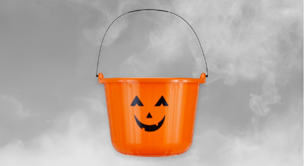 An orange jack-o'-lantern trick-or-treat bucket.