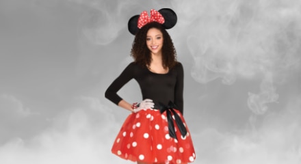 A woman wearing a red polka dot skirt for a Minnie Mouse costume.