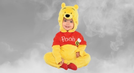 A baby wearing a Winnie the Pooh costume.