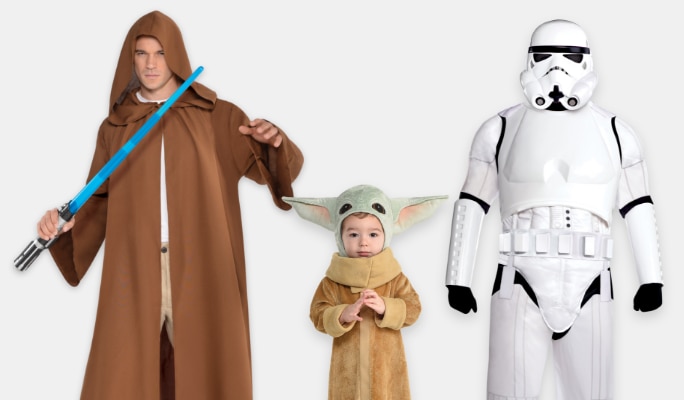 A man wearing a Star Wars Jedi costume holding a light sabre beside an infant wearing a Grogu costume and a person wearing a stormtrooper costume.