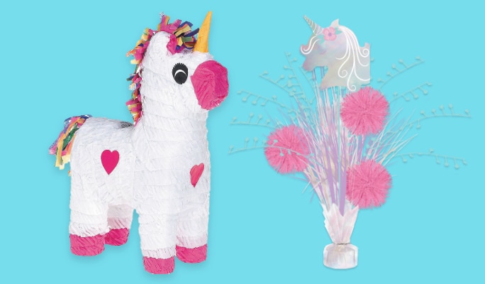 A unicorn piñata beside a unicorn spray centrepiece. 