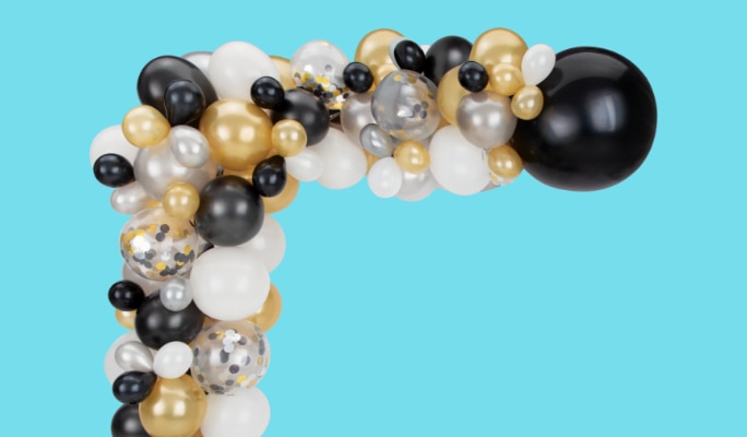 A black, gold silver and white balloon garland.