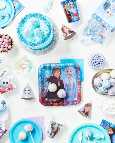 An overhead shot of a table dressed for a Frozen-themed party.