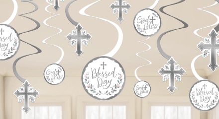 White and silver hanging spiral decorations with the words 'God Bless' and 'Blessed Day' printed on the front beside hanging crosses.