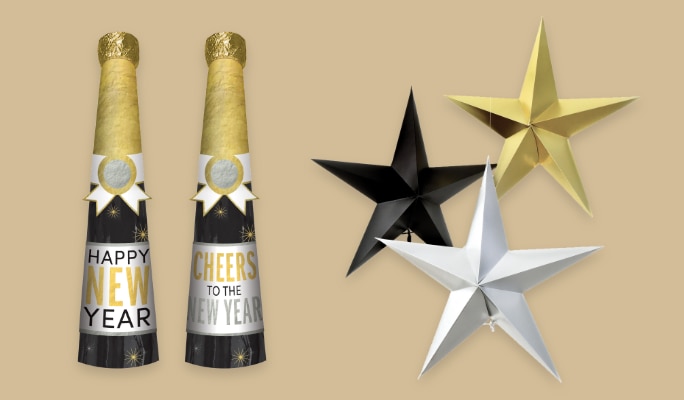 Two 'Happy New Year' champagne nottle-shaped balloons beside  black, gold and silver star decorations.