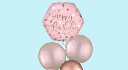 Pink and rose gold balloon bouquet with 'Happy Birthday' printed on the front.