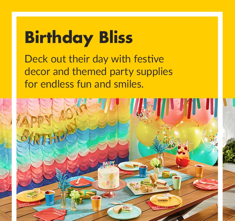 A rainbow-themed birthday celebration with banners, balloons and a cake.