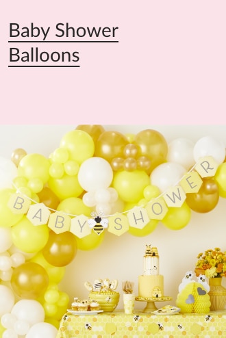 A baby shower garland hangs in front of a cluster of white, yellow and gold balloons.