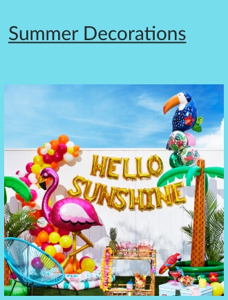 Summer party decorations including inflatable palm trees, a balloon arch, a flamingo balloon and balloon letters spelling out "Hello Sunshine."