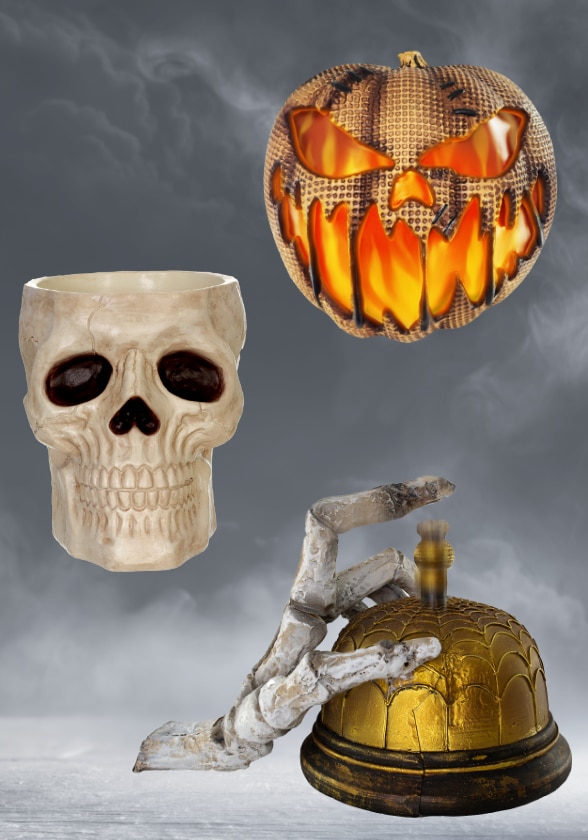 Halloween decorations including a skull, a jack-o'-lantern, and a skeleton hand ringing a bell.
