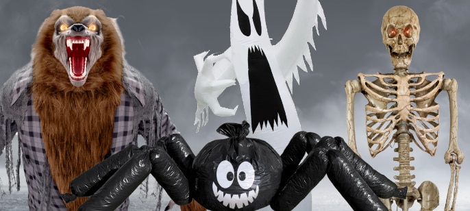 A group of Halloween decorations: a werewolf, a ghost, a skeleton, and an inflatable spider.