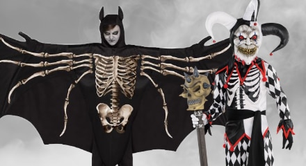 Two people wearing scary costumes.