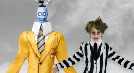 Two people in Beetlejuice-themed Halloween costumes: the Shrunken Head Guy and Beetlejuice.