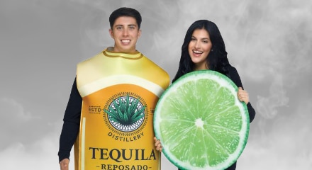 Two people in costumes: a tequila bottle and a slice of lime.