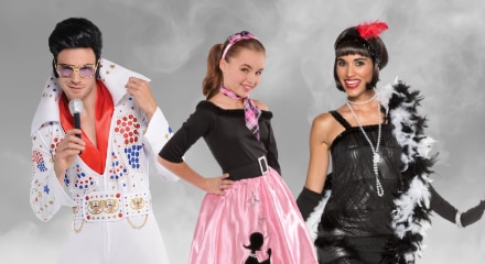 Three people in retro costumes: Elvis Presley,  a 1950s poodle skirt girl, and a 1920s flapper.