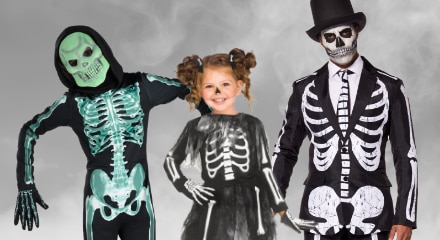Three people dressed in skeleton costumes.