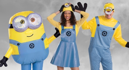 Three people dressed as Minions from the Despicable Me series, wearing yellow and blue costumes with goggles.