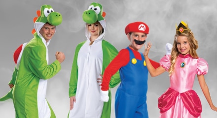Four people dressed as characters from the Super Mario series: two Yoshis, Mario, and Princess Peach